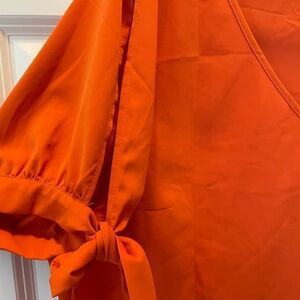 V-neck, peek a boo sleeves with sleeve ties 3/4 sleeve